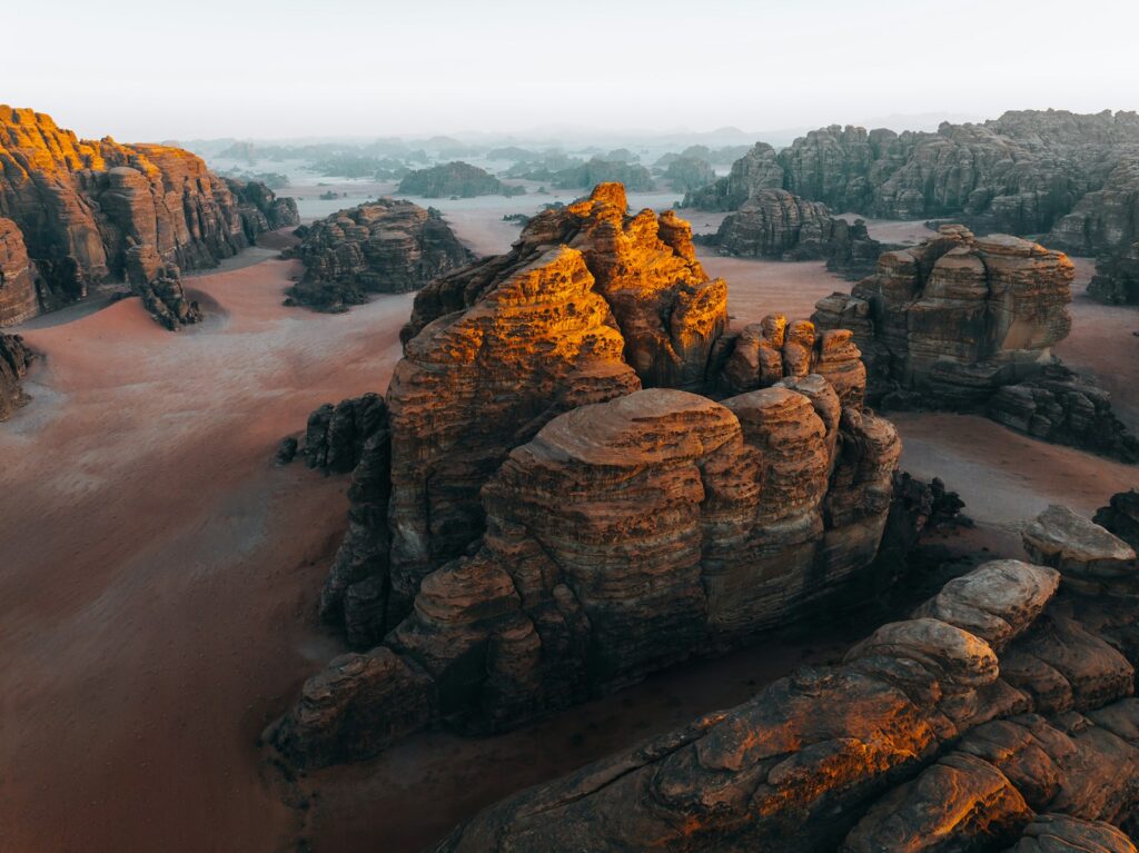 an aerial view of a desert with rocks and sand